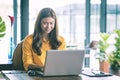 Beautiful Attractive Asian woman working with computer laptop and thinking to get ideas and requirement in Business startup Royalty Free Stock Photo