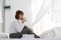 Beautiful Attractive Asian young woman sitting on wooden chair and relax with coffee Royalty Free Stock Photo