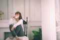 Beautiful Attractive Asian young woman sitting on wooden chair and relax with coffee after wake up in the morning Royalty Free Stock Photo