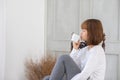 Beautiful Attractive Asian young woman sitting on wooden chair and relax with coffee after wake up in the morning Royalty Free Stock Photo