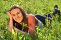 Beautiful attractive brunette girl is lying on a meadow Royalty Free Stock Photo