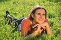 Beautiful attractive brunette girl is lying on a meadow Royalty Free Stock Photo