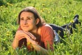 Beautiful attractive brunette girl is lying on a meadow Royalty Free Stock Photo