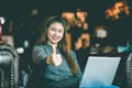 Beautiful Attractive Business Asian woman working with laptop looking in monitor smile and showing Thumbs up Royalty Free Stock Photo