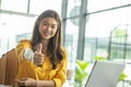 Beautiful Attractive Business Asian woman working with laptop looking in monitor smile and showing Thumbs up have positive emotion Royalty Free Stock Photo