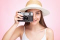 A beautiful, attractive female photographer holds a vintage camera. Tourism and travel concept