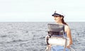 Beautiful, attractive sailor girl driving a boat. Sea, navigation concept.