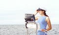 Beautiful, attractive sailor girl driving a boat. Sea, navigation concept.