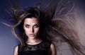 Beautiful attractive young Brazilian fashion model with hair blown by the air studio shot