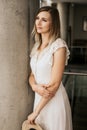 Beautiful attractive woman wearing white dress indoor