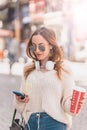 Beautiful woman uses smartphone while walking Royalty Free Stock Photo