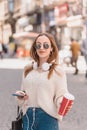 Beautiful woman uses smartphone while walking Royalty Free Stock Photo