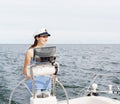 Beautiful, attractive young girl pilots a boat Mediterranean Sea