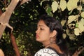 Beautiful attractive young Indian Hindu Woman model relaxing in the garden during summer