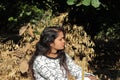 Beautiful attractive young Indian Hindu Woman model relaxing in the garden during summer