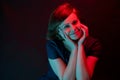 Beautiful attractive young woman posing in neon light in studio Royalty Free Stock Photo