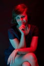 Beautiful attractive young woman posing in neon light in studio Royalty Free Stock Photo