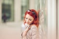 Beautiful, attractive young woman with red hair relaxing in town, shopping Royalty Free Stock Photo