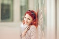 Beautiful, attractive young woman with red hair relaxing in town, shopping Royalty Free Stock Photo