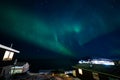 Beautiful aurola northen light over the town cityscap. Northen lights in south kitaa Qaqortoq Greenland