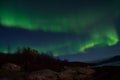 Beautiful aurora borealis dancing over mountain and fjord landscape on late autumn night Royalty Free Stock Photo