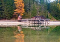 Beautiful autumn alpine landscape, old wooden dock house with pier on Braies lake, Dolomites, Italy Royalty Free Stock Photo