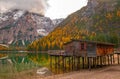 Beautiful autumn alpine landscape, spectacular old wooden dock house with pier on Braies lake, Dolomites, Italy Royalty Free Stock Photo