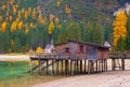 Beautiful autumn alpine landscape, spectacular old wooden dock house with pier on Braies lake, Dolomites, Italy Royalty Free Stock Photo