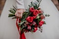 Beautiful autumn bouquet with red flowers and succulents in the bride`s hand Royalty Free Stock Photo