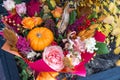 Beautiful autumn bouquet with rose flowers, pumpkin and fall leaves