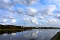 Beautiful autumn city landscape with view of river. Clouds are reflected in water on sunny day. Distance is Catherine Monastery. Royalty Free Stock Photo