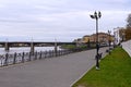 Beautiful autumn cityscape with view of embankment, river and bridge over it. Architecture of small town. Concept of tourism