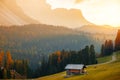 Beautiful autumn colors at the foot of the Odle Mountains in the backdrop of the Seceda Mountains at sunset in the Dolomites, Royalty Free Stock Photo