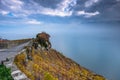 Beautiful autumn colors on the terraces of the Lavaux vineyards in Switzerland and foggy, dark threatening clouds over Lake Geneva