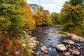 Mountain river with wooded banks on a aprtly autumn day Royalty Free Stock Photo