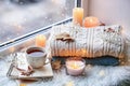 Beautiful autumn composition with burning candles and cup of tea on window sill Royalty Free Stock Photo