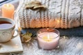 Beautiful autumn composition with burning candles and cup of tea on window sill Royalty Free Stock Photo