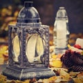 Beautiful autumn concept to the cemetery and Halloween. Candle in a lantern on the grave. Background for Halloween. Royalty Free Stock Photo