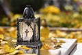 Beautiful autumn concept to the cemetery and Halloween. Candle in a lantern on the grave. Background for Halloween. Royalty Free Stock Photo