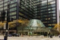 a beautiful autumn day in the city with skyscrapers, office buildings and hotels, autumn colored trees. people walking and cars Royalty Free Stock Photo