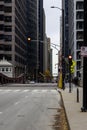 a beautiful autumn day in the city with skyscrapers, office buildings and hotels, autumn colored trees, people walking and cars Royalty Free Stock Photo