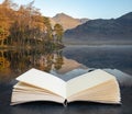 Beautiful Autumn Fall colorful sunrise over Blea Tarn in the Lake District with High Raise and The Langdales in the distance Royalty Free Stock Photo