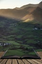 Beautiful Autumn Fall landscape image of sun beams lighting up small area of mountain side in Lake District coming out of pages of Royalty Free Stock Photo