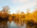 Beautiful autumn lake scene sunset light golden on trees sky spa Royalty Free Stock Photo