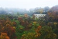 Beautiful autumn landscape with abandoned mysterious house in the fog