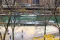 A beautiful autumn landscape along the Chicago River with yellow autumn trees, boats on the water and skyscrapers and hotels