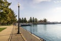 A beautiful autumn landscape along Lake Michigan with boats docked on the blue water, autumn trees and lush green grass, blue sky Royalty Free Stock Photo