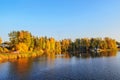 Beautiful autumn landscape on the background of the river. Colorful bright tree leaves, red, orange, yellow, green. Royalty Free Stock Photo