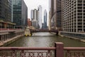 a beautiful autumn landscape with cars driving over the Monroe Street bridge over the Chicago River and skyscrapers