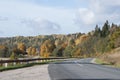 Beautiful autumn landscape with colorful trees and road downhill Royalty Free Stock Photo